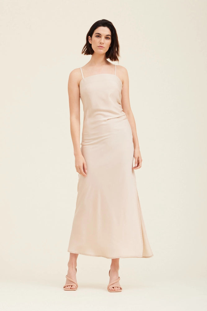 
                      
                        An ecru colored gathered side midi slip dress 
                      
                    