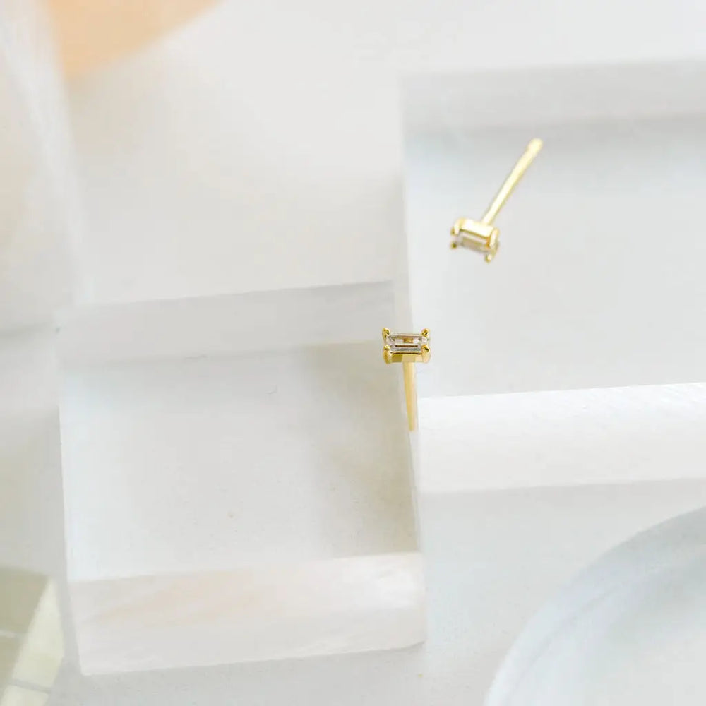 The Dara Clear CZ Baguette Gold Stud Earrings by The Land Of Salt