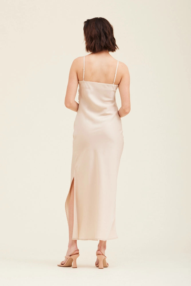 
                      
                        Back view of an ecru colored gathered side midi slip dress 
                      
                    