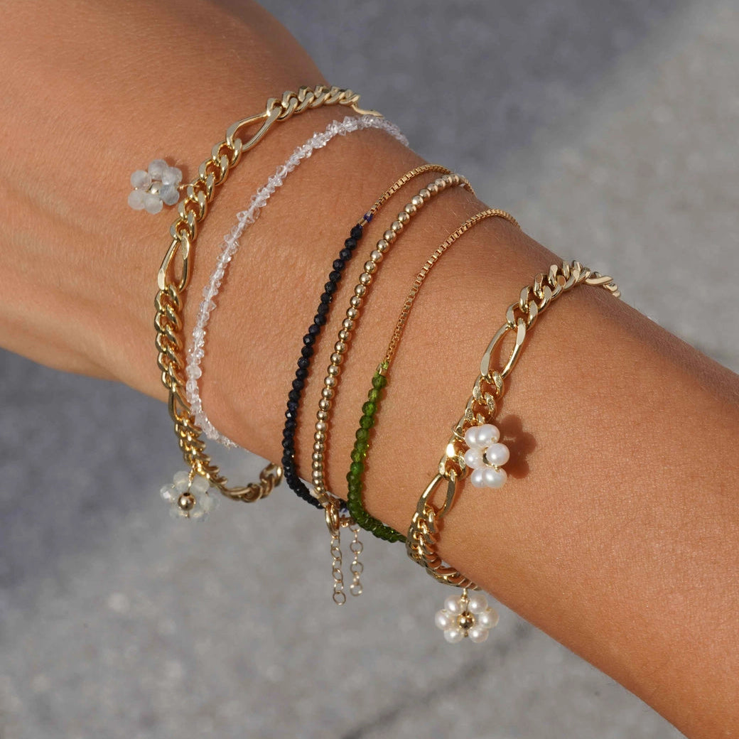 Close-up of a wrist wearing multiple bracelets from the brand KOZAKH