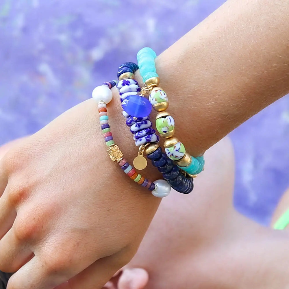 A person wearing multiple Catherine Page Jewelry bracelets