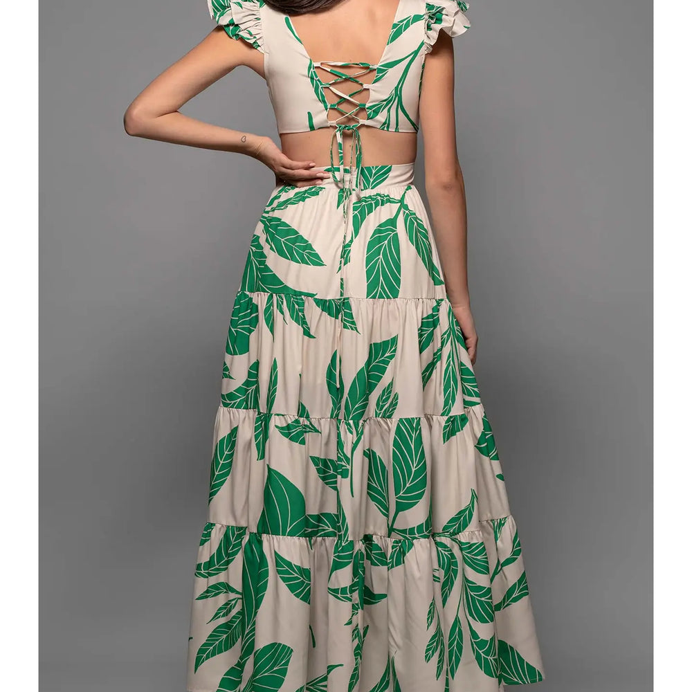 Shop this palm leaf print maxi dress with tiered skirt, ruffled sleeves and strappy back tie detail at Harbour Thread for stunning, vacation-ready style. 