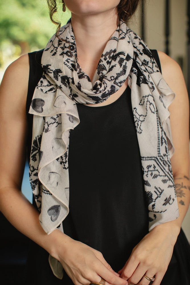 
                      
                        A woman with the Token of Love Printed Bamboo Scarf by Market of Stars fashion around her neck
                      
                    