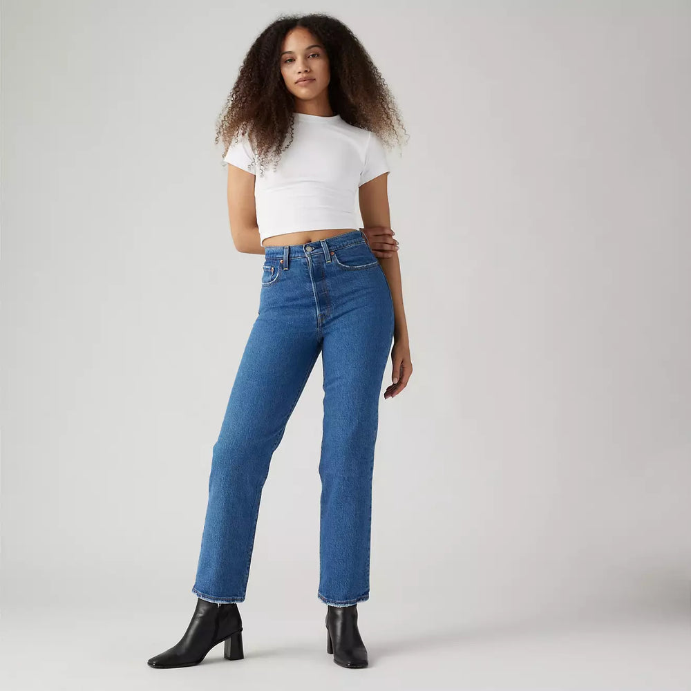 Front view of a woman wearing the azz Pop Medium Wash Ribcage Straight Ankle Women's Jeans by Levi’s