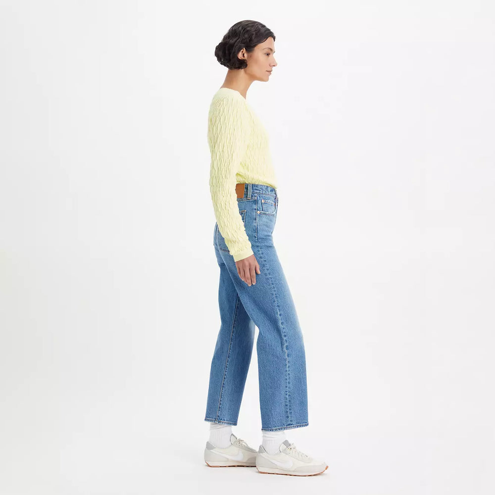 
                      
                        Side view of a woman wearing the Levi's Ribcage Straight Ankle Jeans in the color Dance Around
                      
                    