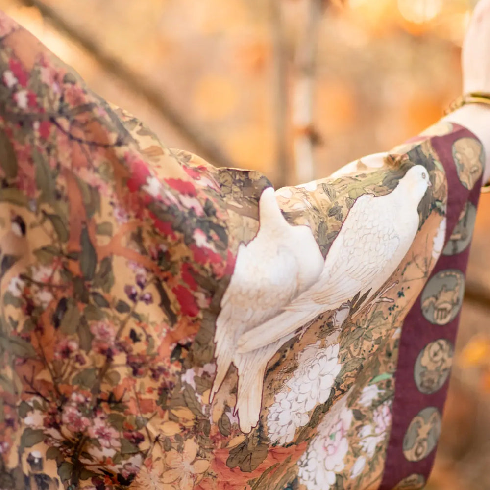 
                      
                        Doves on the kimono sleeve of the Dreamweaver Zodiac Duster Robe by the brand Market Of Stars
                      
                    