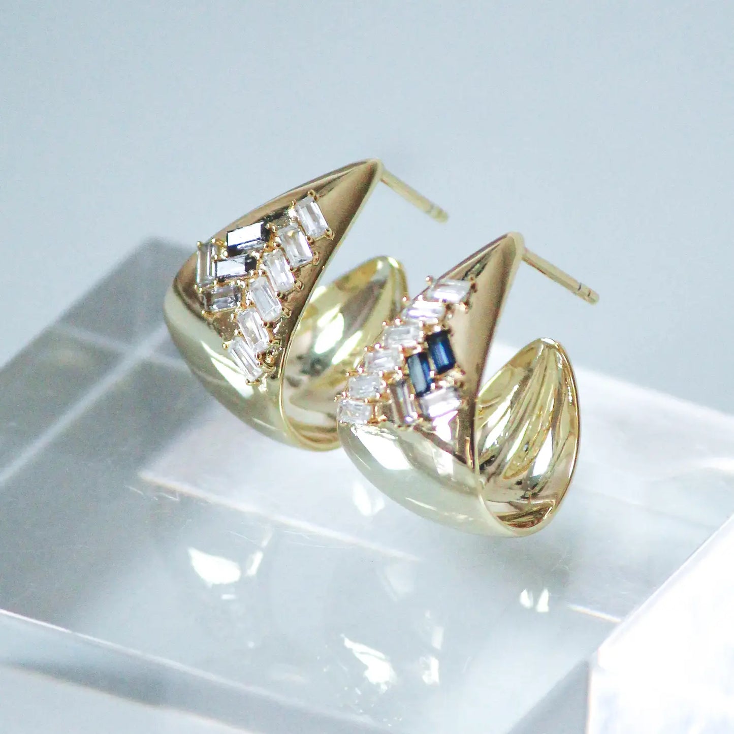 These 14K gold vermeil hoop earrings feature Black, Gray and Clear baguettes.
