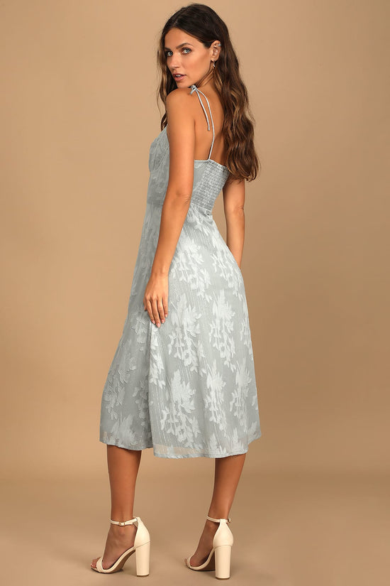 Back view of woman wearing a Dusty Blue Floral Jacquard Tie-Strap Midi Dress