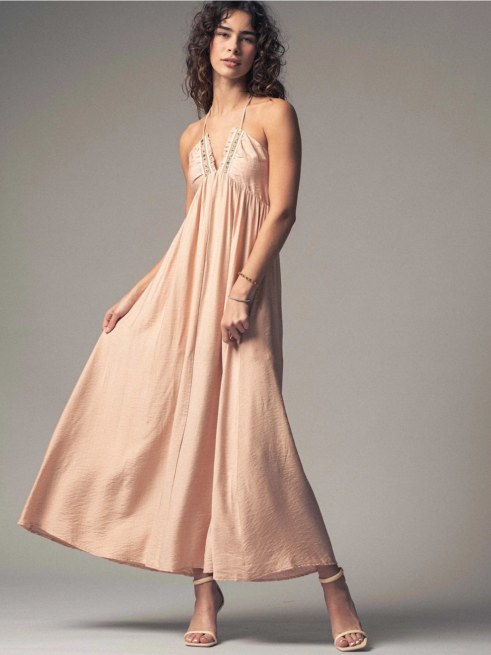 Pretty and flowy, this lightweight halter dress at Harbour Thread Burlington features a smocked back for a secure fit and delicate lace-trimmed detailing. 