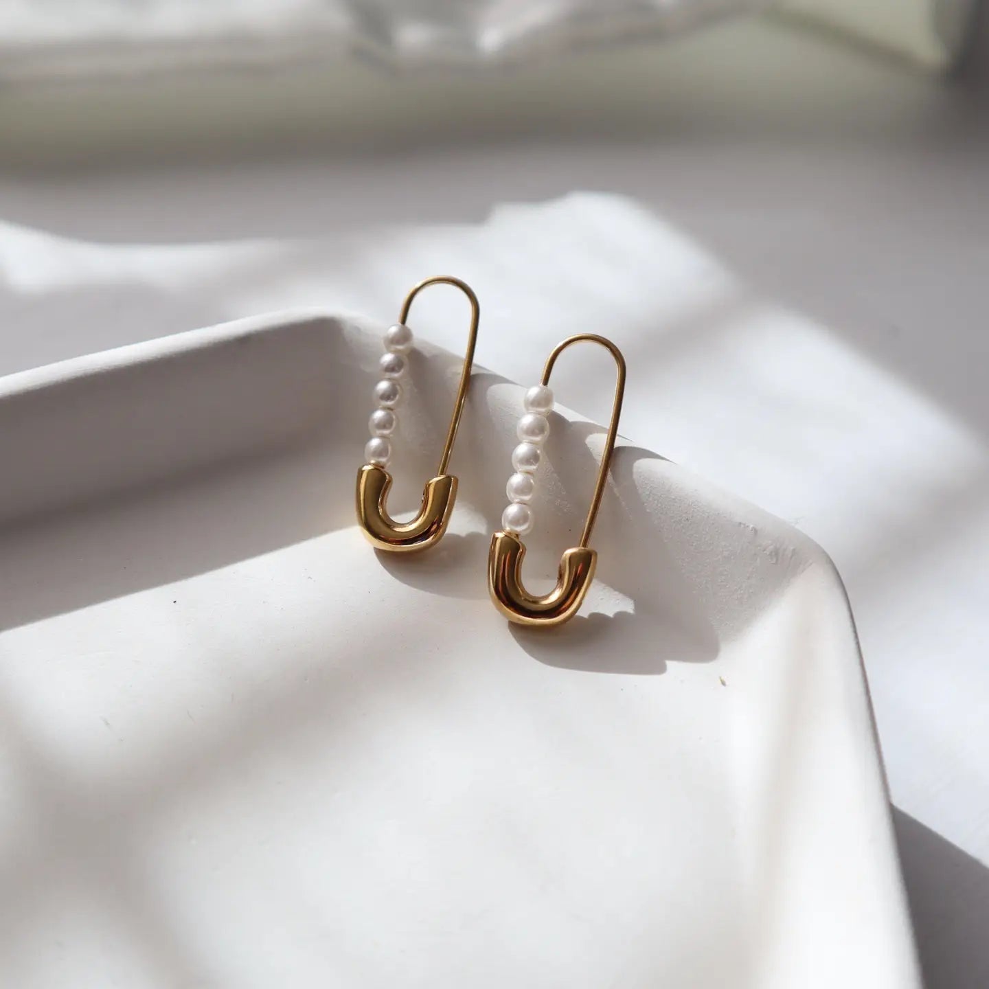 Safety pin style earrings with lightweight pearl details