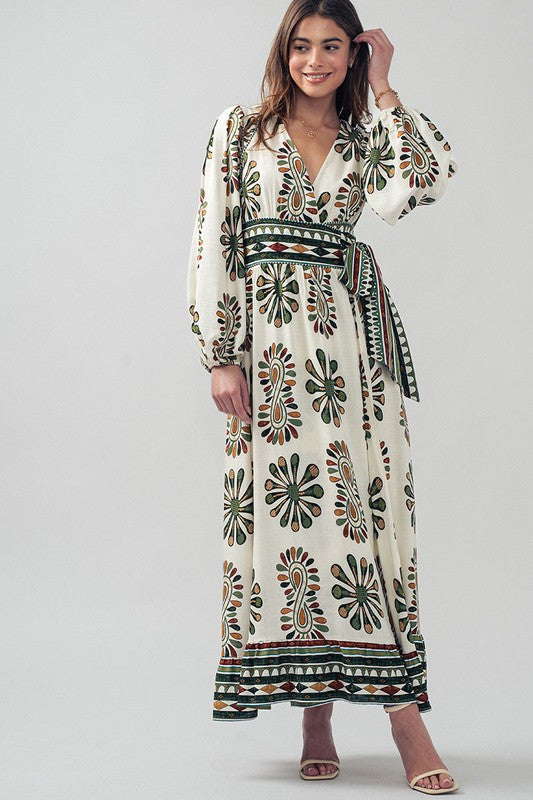 This flattering wrap style printed maxi dress at Harbour Thread Burlington features long blouson sleeves and adds bohemian flare to an elevated resort look. 