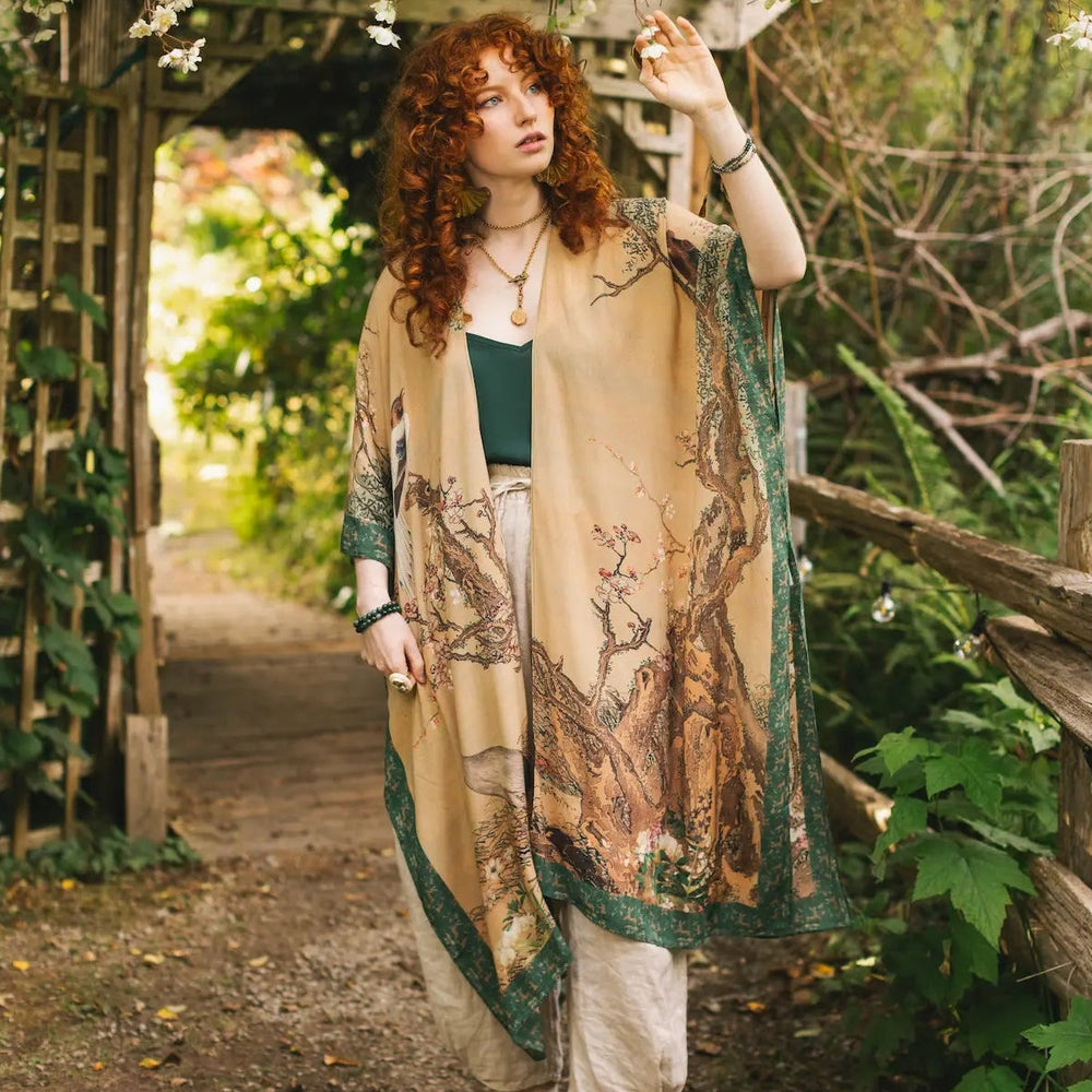 A woman wearing the Fable Bohemian Goddess Starduster Kimono with Deer and Moon by Market Of Stars