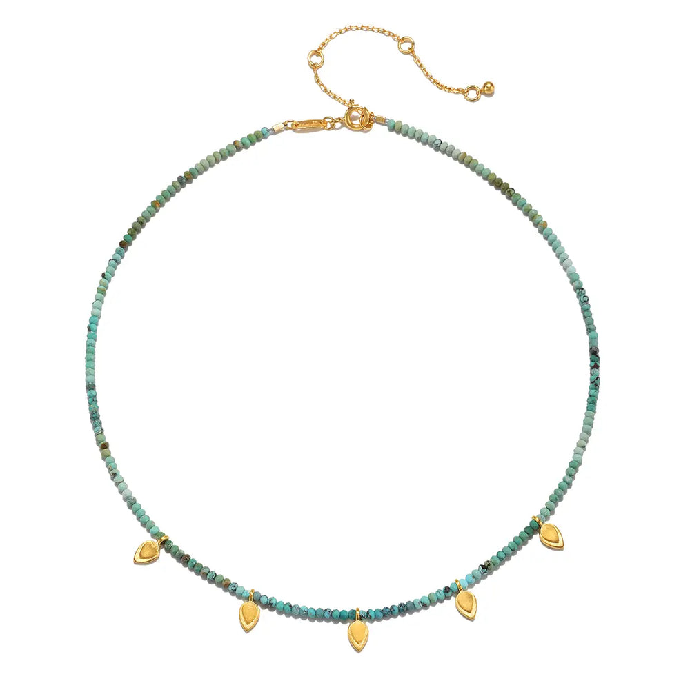 
                      
                        A choker necklace of turquoise beads  accented with fluttering golden lotus petals
                      
                    