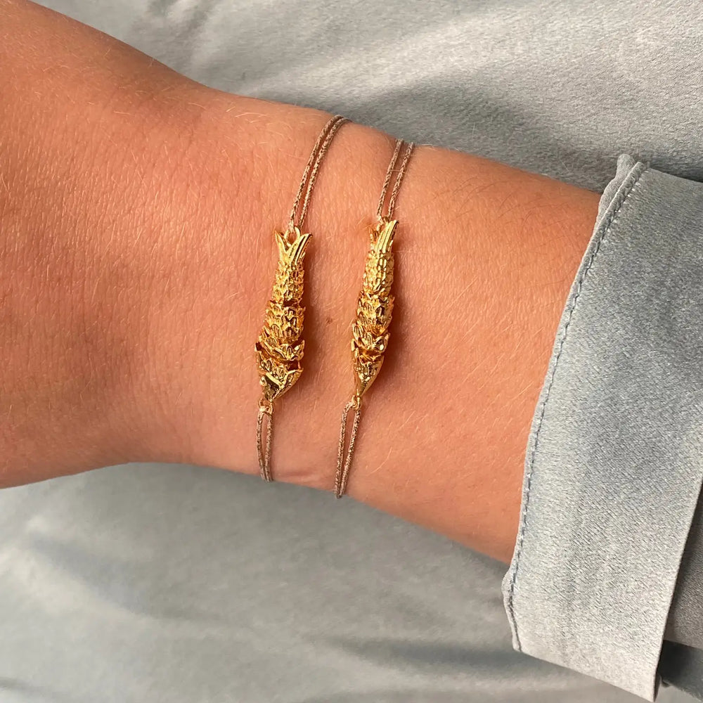 
                      
                        Person wearing 2 Sardina Gold Plated Fish Bracelet by Sophie Deschamps Bijoux
                      
                    