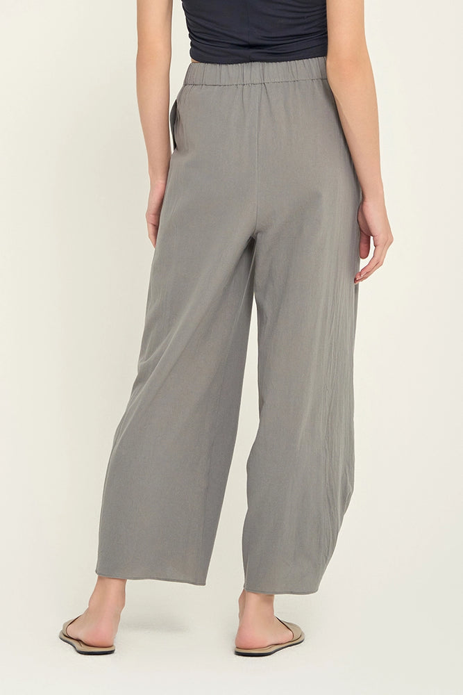 
                      
                        back view of woman wearing grey knotted hem pants
                      
                    