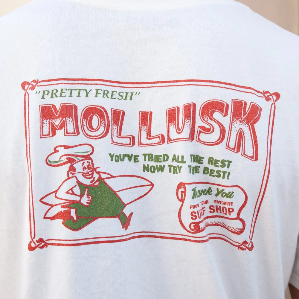 White t-shirt with red and green graphic design on the back, featuring the text 'Pretty Fresh Mollusk' and a cartoon character.