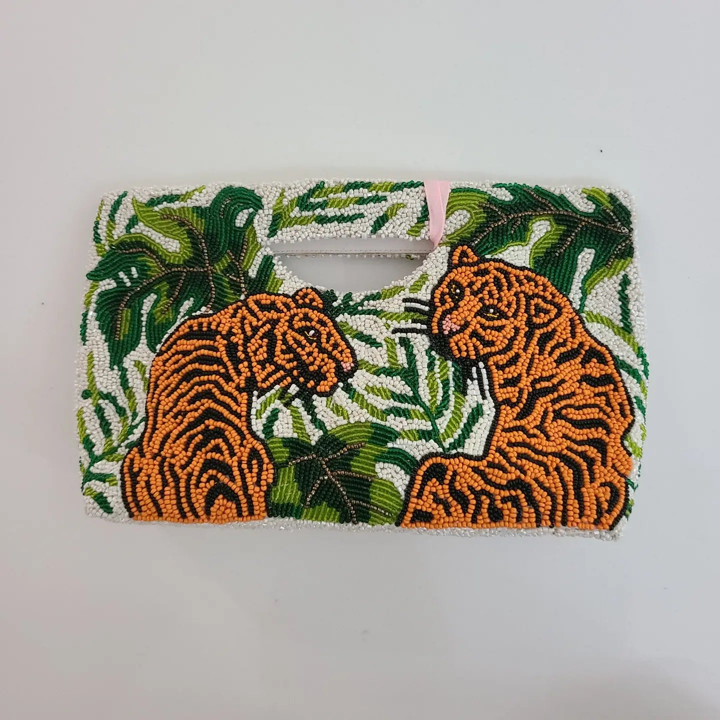 A fully beaded handbag with a tigers and botanical design