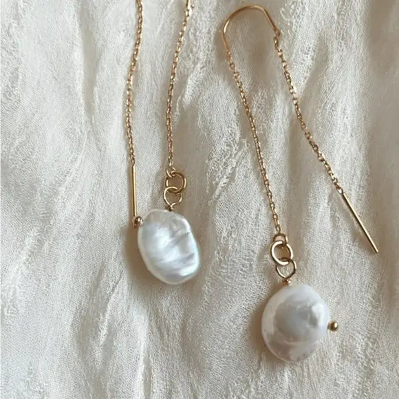 Add timeless elegance to your look with the Tramps + Thieves Peia Threader Earrings, available at Harbour Thread.
