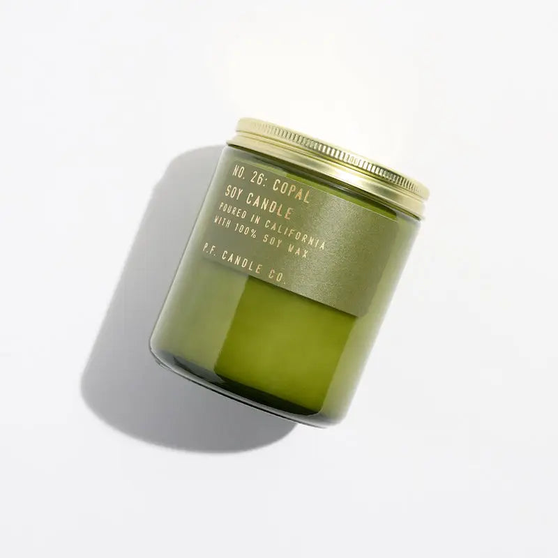 
                      
                        The Copal Soy Candle by P.F. Candle Co packaged in a green jar with a lid
                      
                    