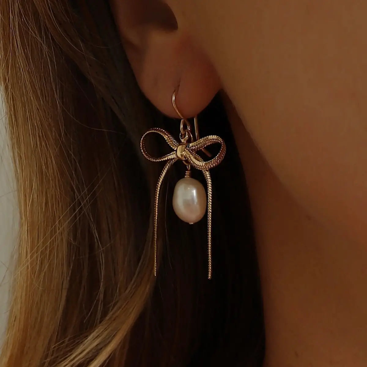 The Katie Waltman Jewelry Sloane Ribbon and Pearl Earrings are the perfect bridal accessory