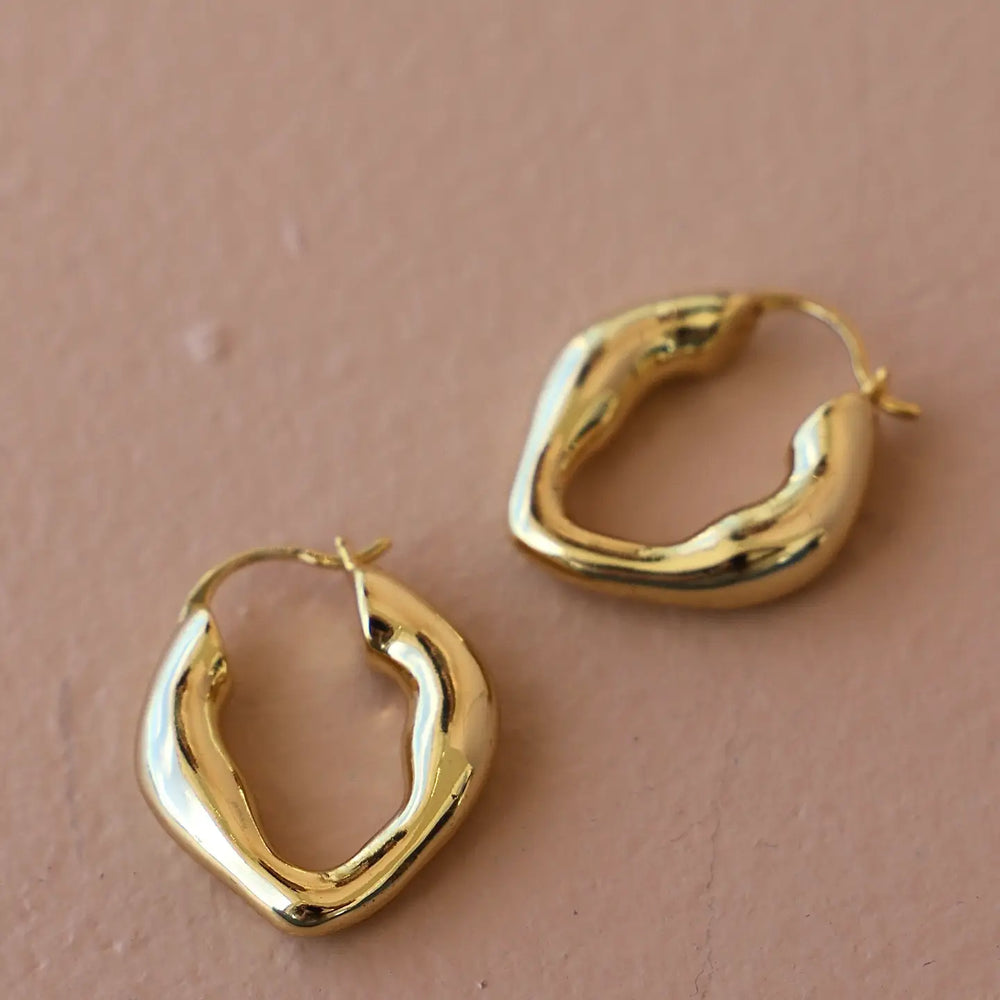 The Katie Waltman Jewelry Organic Gold Hoops are crafted from 14K Gold plated brass