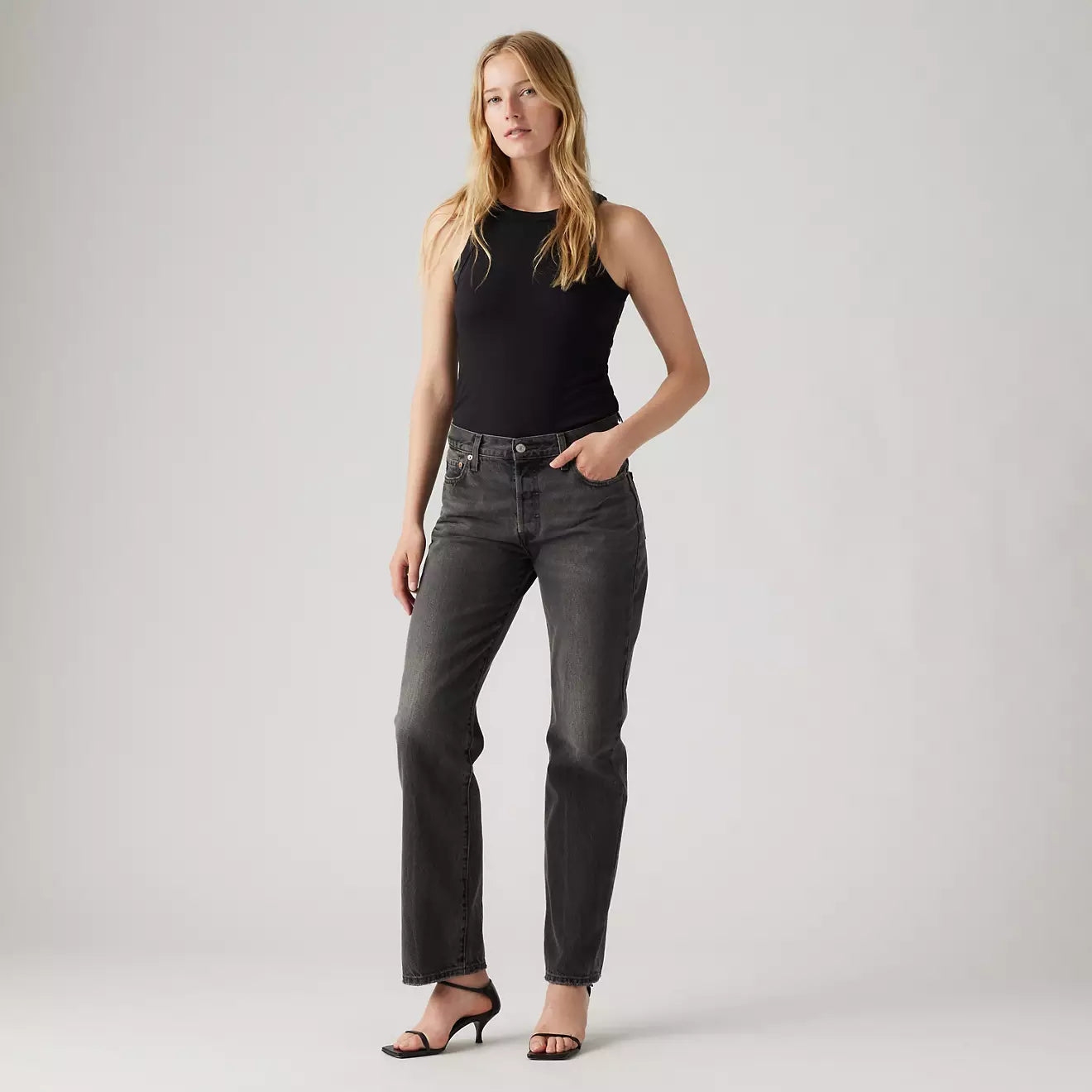 A woman wearing the Stitch School Black 501 90's Women's Jeans by Levi's. 