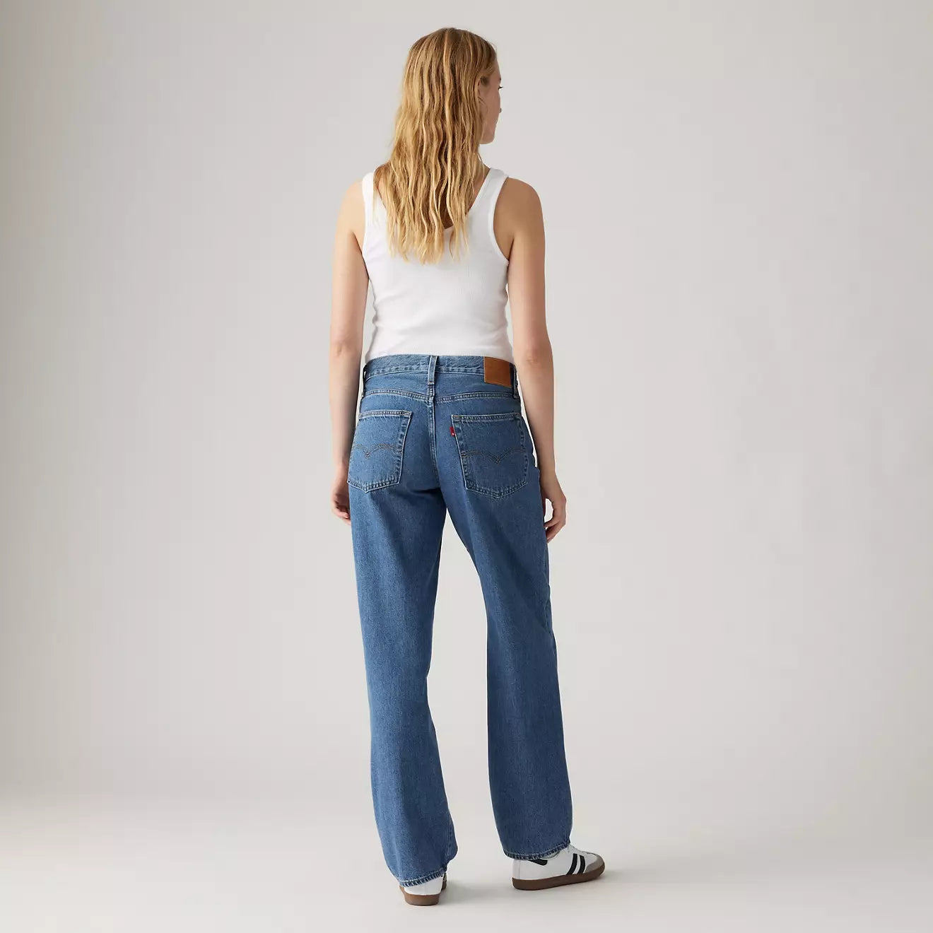 Back view of a woman wearing the Hold My Purse Medium Wash Baggy Dad Women's Jeans by Levi's