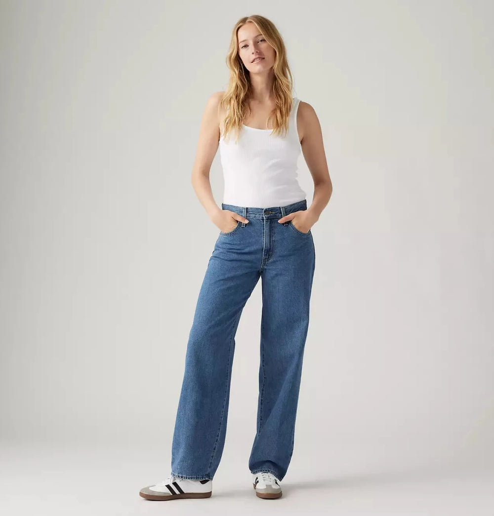 Front view of a woman wearing the Hold My Purse Medium Wash Baggy Dad Women's Jeans by Levi's