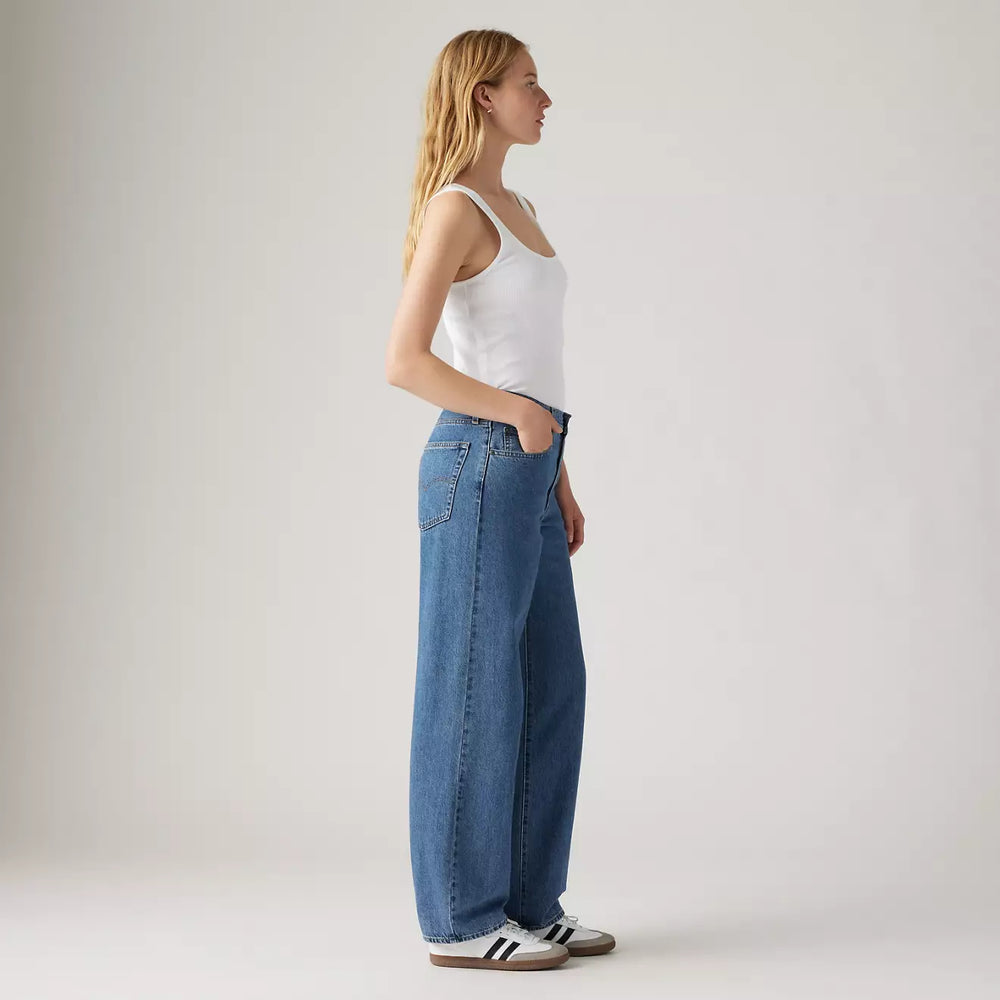 
                      
                        Side view of a woman wearing the Hold My Purse Medium Wash Baggy Dad Women's Jeans by Levi's
                      
                    