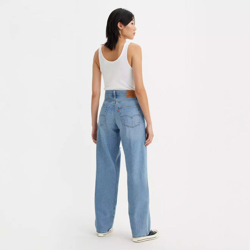 
                      
                        Back view of a woman wearing the In The Middle Medium Wash Distressed Baggy Dad Women's Jeans by Levi's
                      
                    