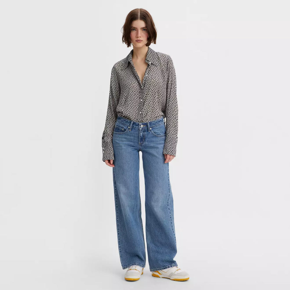 Front view of a woman wearing the Real Recognize Real Medium Wash Low Loose Wide Leg Women's Jeans by Levi’s