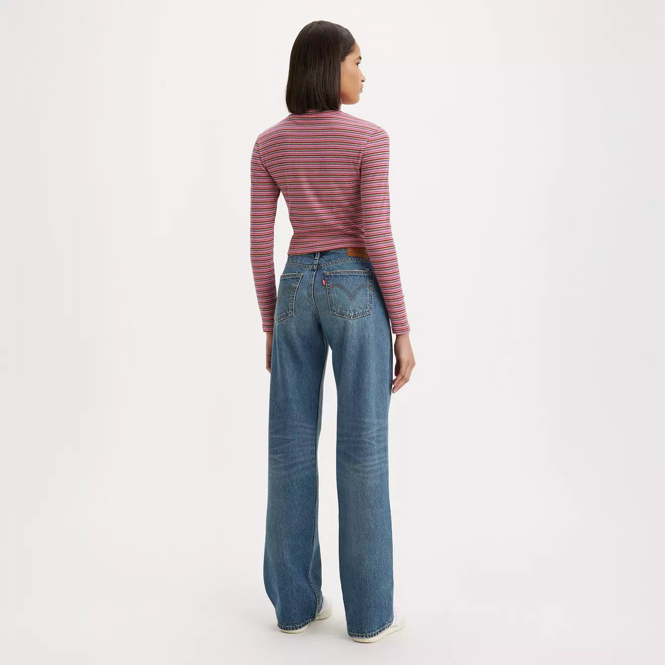 Back view of a woman wearing the Good Life Dark Wash Low Loose Wide Leg Women's Jeans by Levi’s