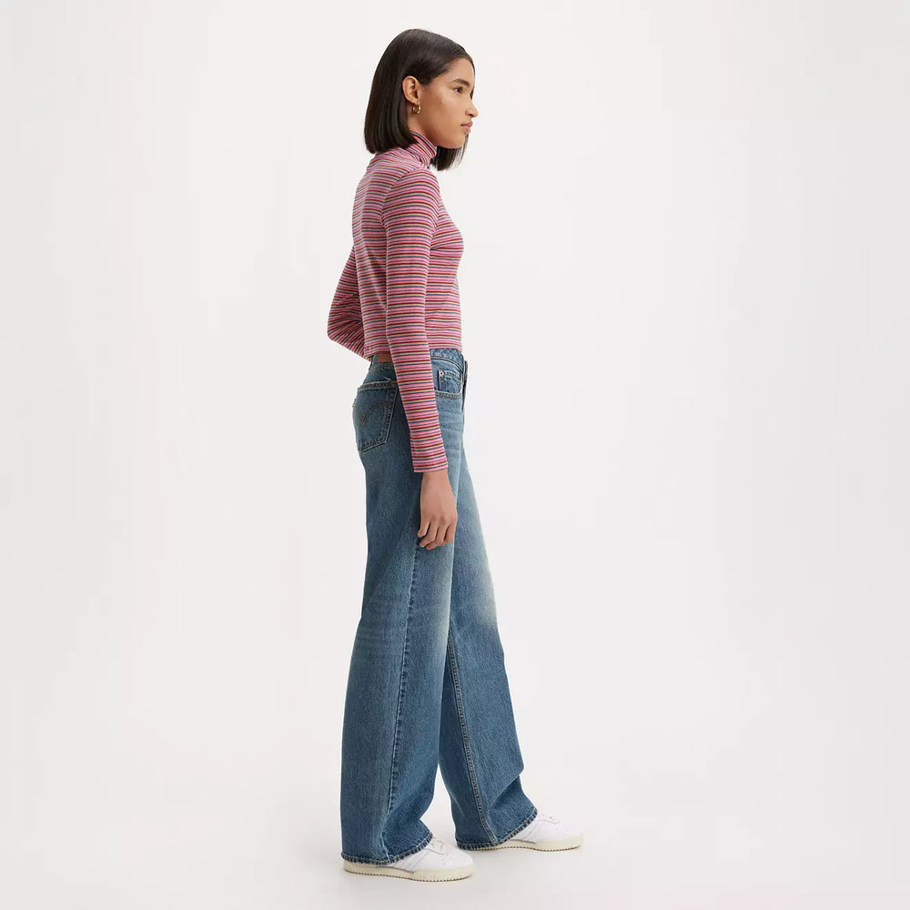 
                      
                        Side view of a woman wearing the Good Life Dark Wash Low Loose Wide Leg Women's Jeans by Levi’s
                      
                    