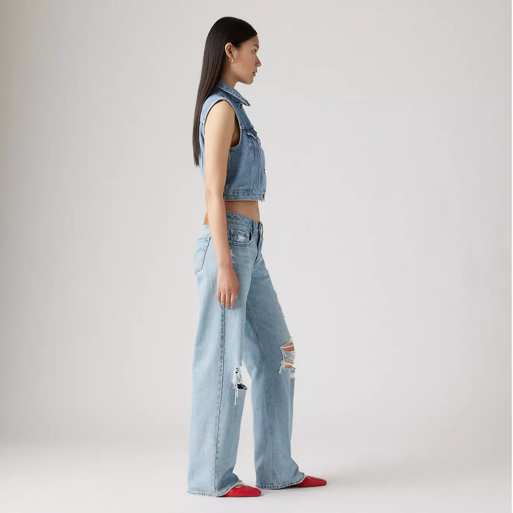 
                      
                        Side view of a woman wearing the Probably Ok Light Wash Distressed Low Loose Women's Jeans by Levi’s
                      
                    