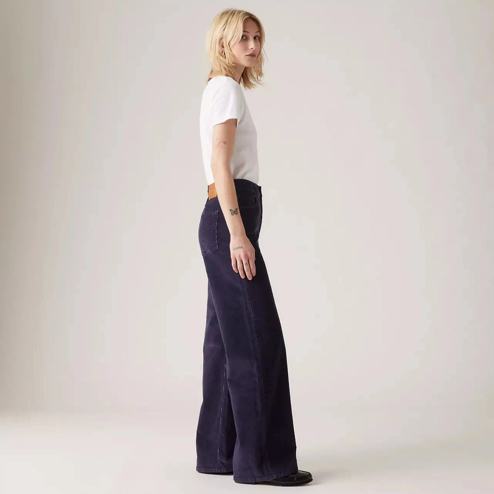 
                      
                        Side view of a woman wearing the Night Sky Ribcage Wide Leg Jeans by Levi's
                      
                    