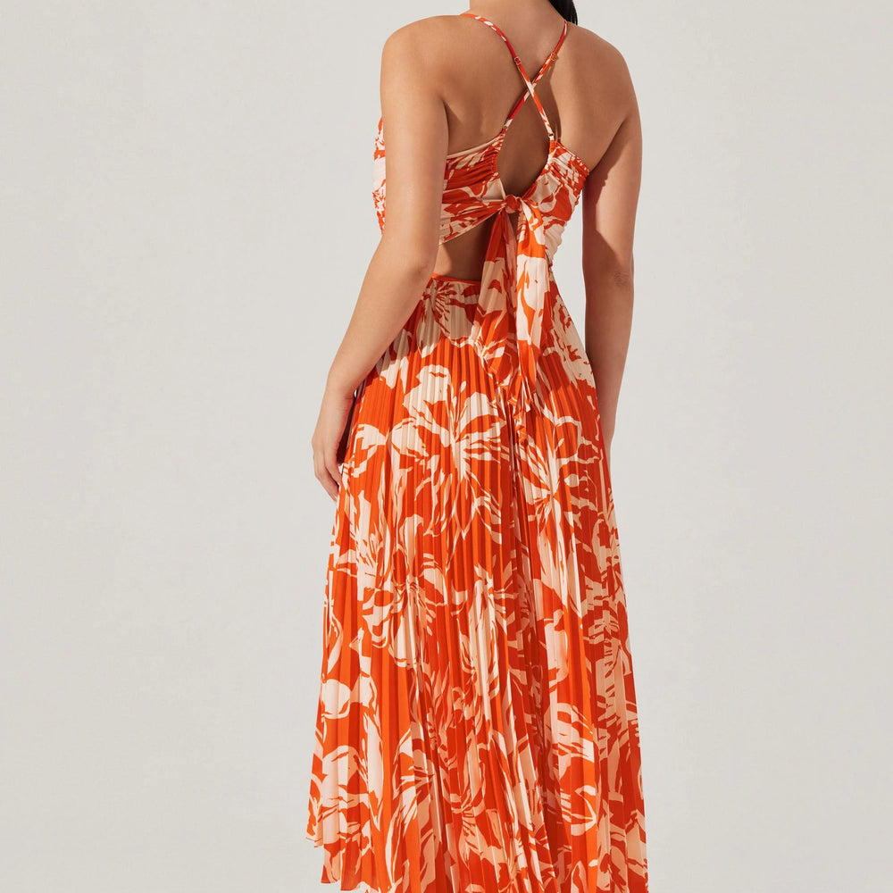 
                      
                        Woman wearing an orange and white patterned dress on a white background
                      
                    