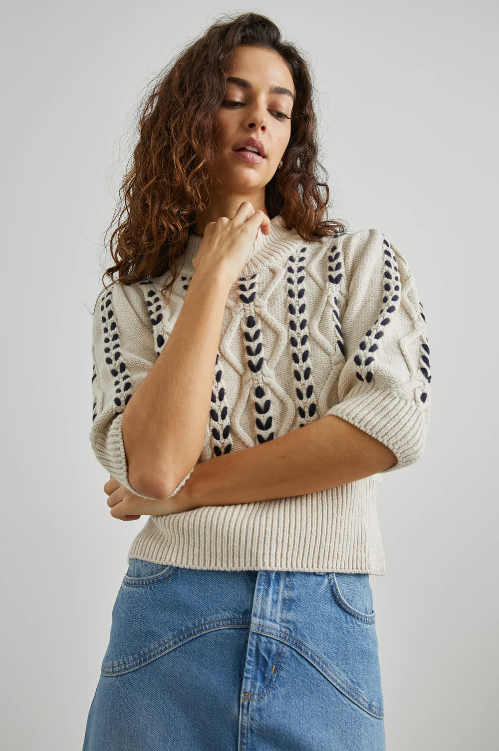 A woman wearing the Addy Cable Knit Sweater by Rails in the color Oatmeal Navy