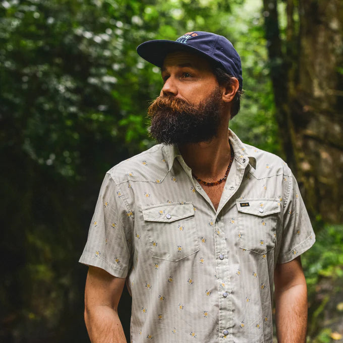 A man outside wearing the Vintage Grid Floral Medium White H Bar B Snapshirt  by Howler Bros