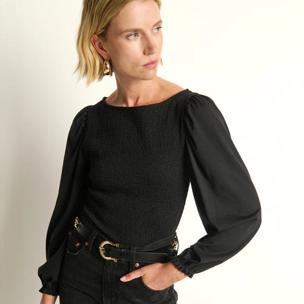 Woman wearing a black blouse with puffed sleeves and black pants by Nation LTD