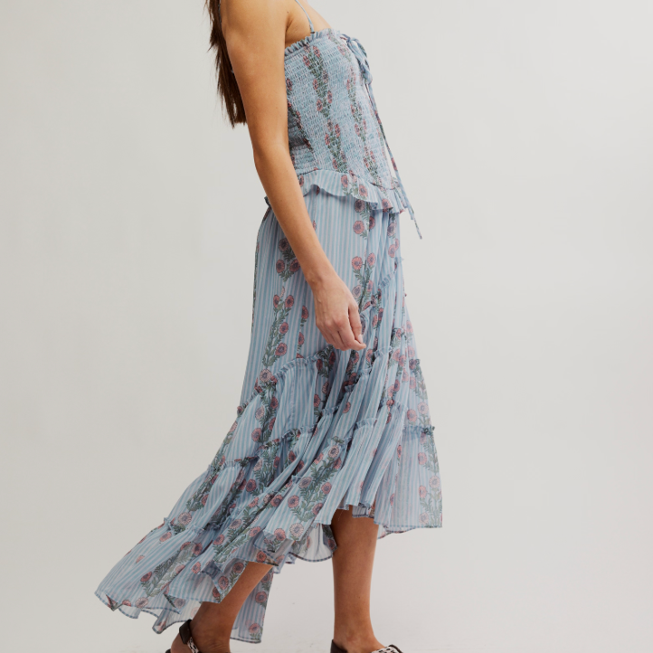 The Free People Alejandra Midi Dress offers vintage-inspired style with a flowy high-low skirt and fitted bodice