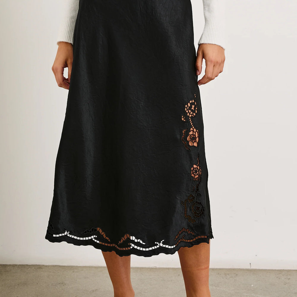 Front view of a woman wearing the Black Eyelet Anya Skirt by the brand Rails.