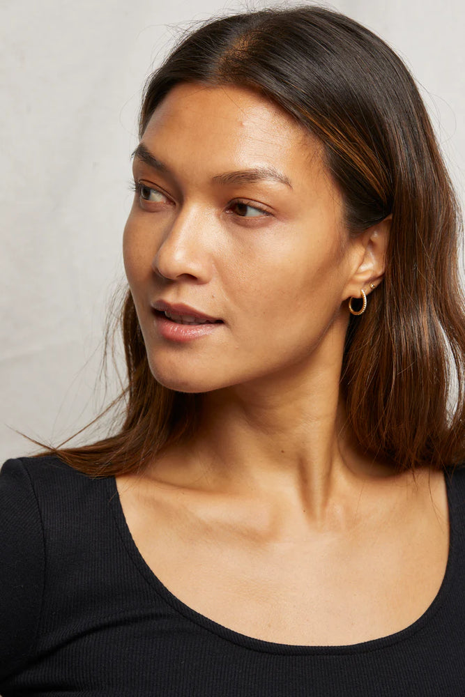 
                      
                        Woman wearing a black scoop neck top
                      
                    