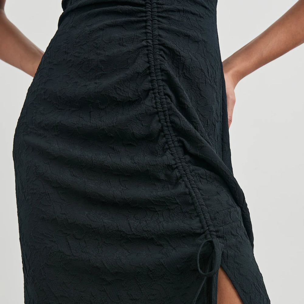 Front view of the ruching detail on the Black Jacquard Auren Midi Dress by the brand Rails