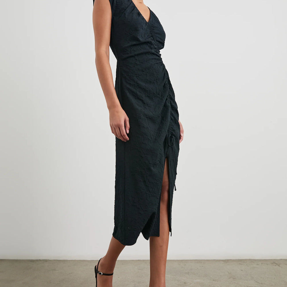 
                      
                        Side view of a woman wearing the Black Jacquard Auren Midi Dress by the brand Rails
                      
                    