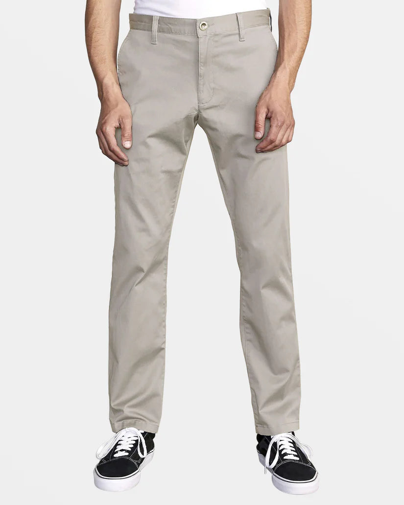 Front view of a man wearing the Mirage Weekend Stretch Straight Fit Pants by RVCA