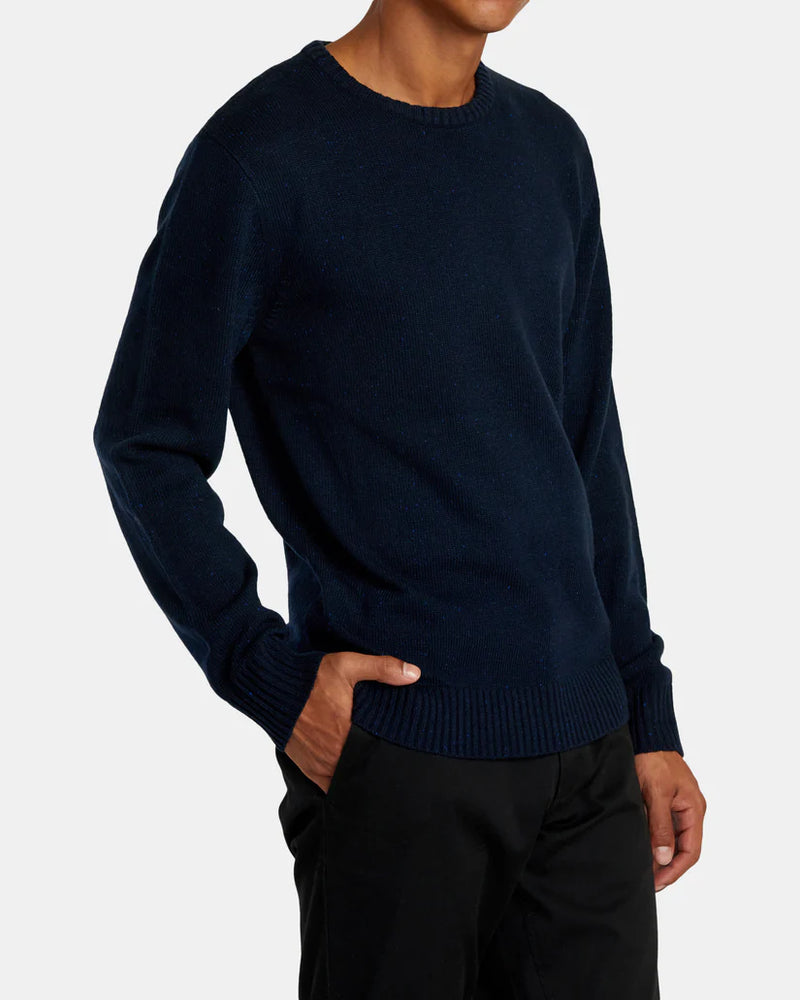 
                      
                        Side view of a man wearing the navy Alameda Crew Neck Sweater by RVCA
                      
                    