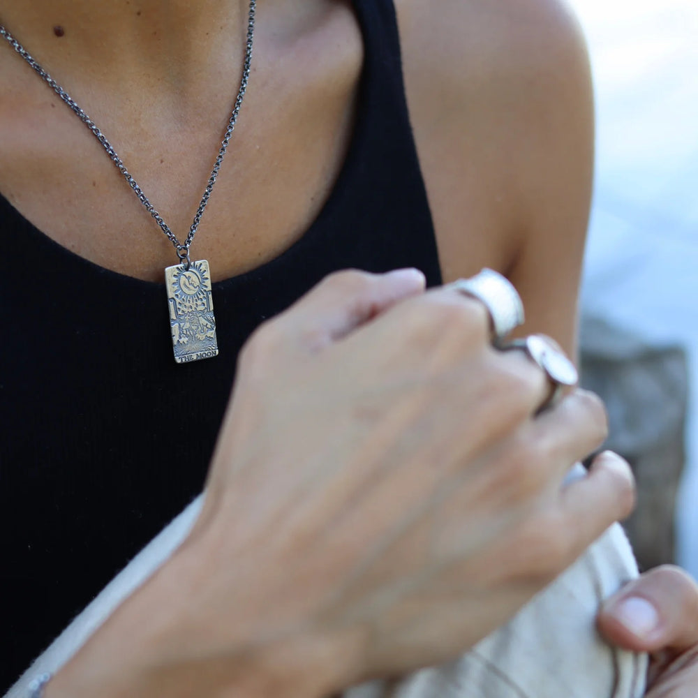 A woman wearing the silver Moon Tarot Pendant Necklace by Jennifer Kahn Jewelry 