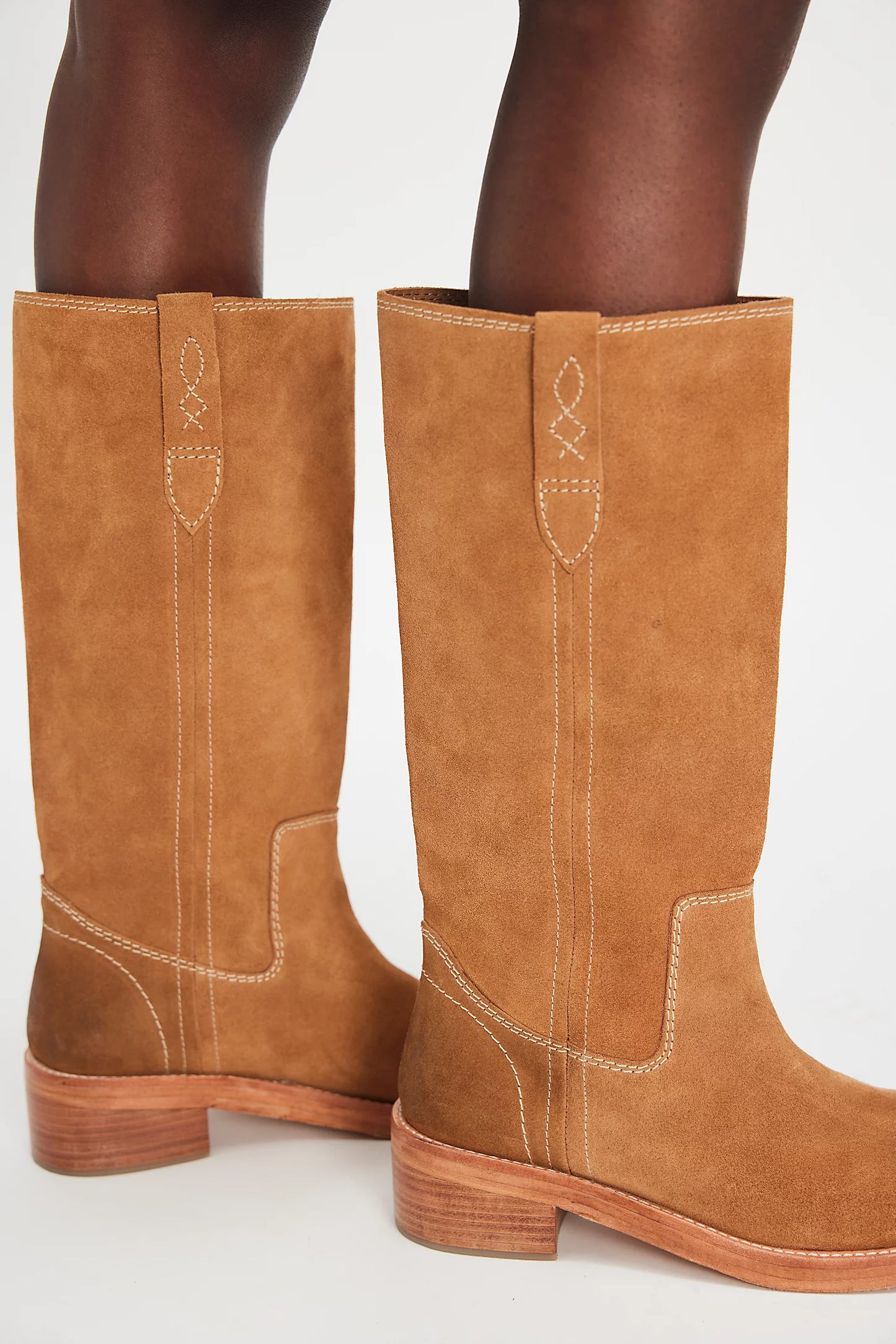 Tan knee-high suede boots from Free People