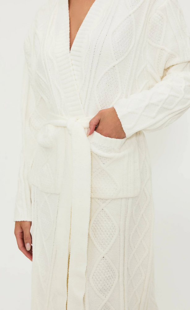 
                      
                        This cable knit robe includes patch pockets and self tie waist
                      
                    