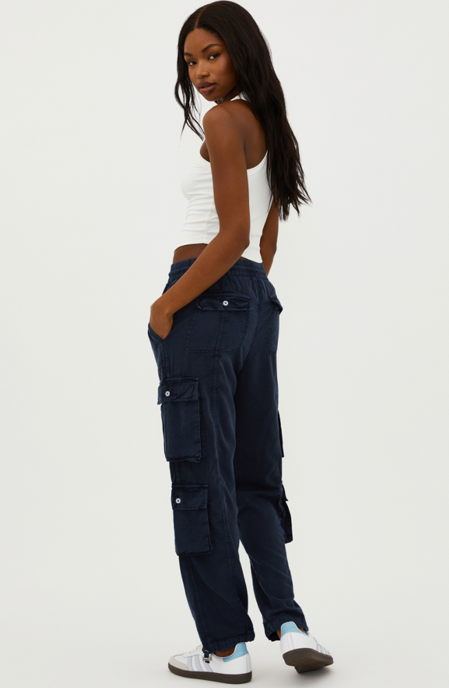 
                      
                        Back view of a woman wearing the Cassius Pant by Beach Riot
                      
                    